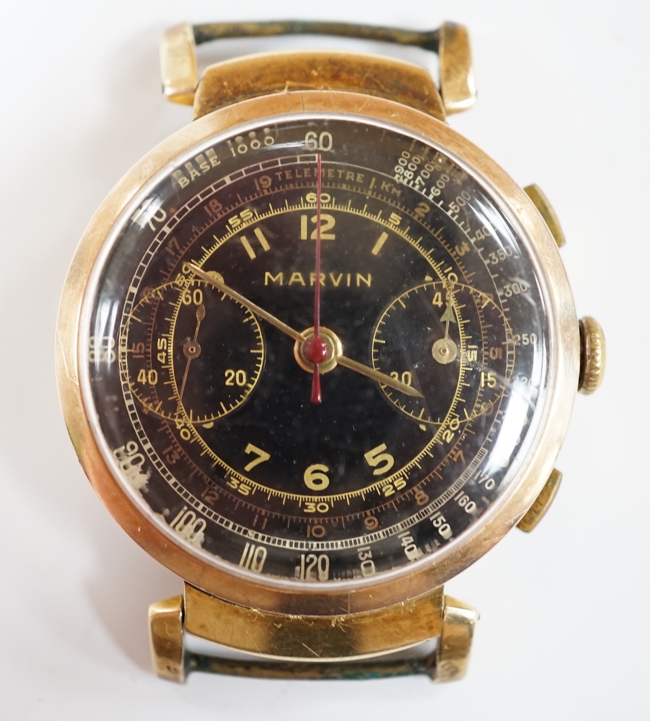 A gentleman's gilt metal Marvin chronograph manual wind black dial wrist watch, no strap, case diameter 36mm.